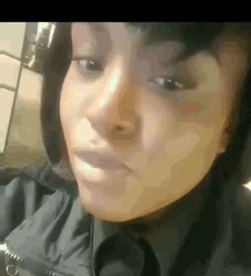 a close up of a woman 's face wearing headphones .