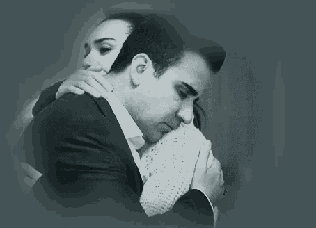 a man and a woman are looking at each other