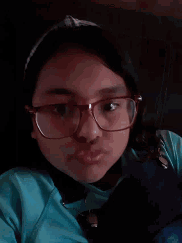 a close up of a person wearing glasses