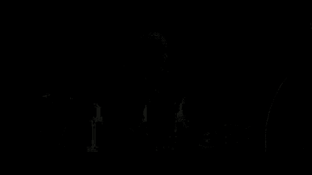 a man sitting in a dark room with the words " all of them " on the bottom