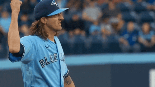 a baseball player wearing a blue jays jersey