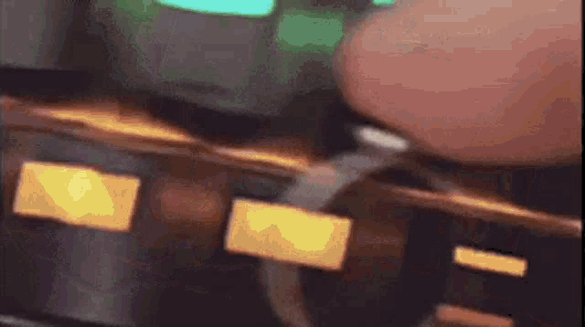 a close up of a person 's hand holding a ring .