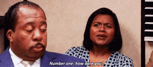 a man and a woman are standing next to each other and the woman is asking the man a question .