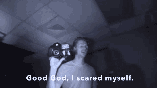 a man holding a camera with the words good god i scared myself above him
