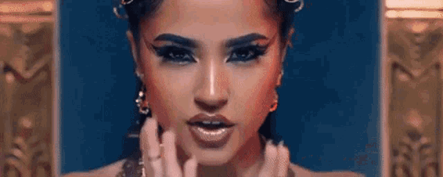 a close up of a woman 's face with a lot of makeup on .