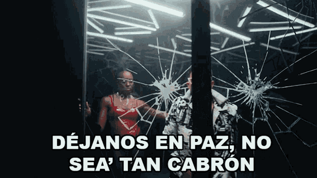 a woman in a red top is standing in front of a broken glass window with the words dejanos en paz no sea tan cabron