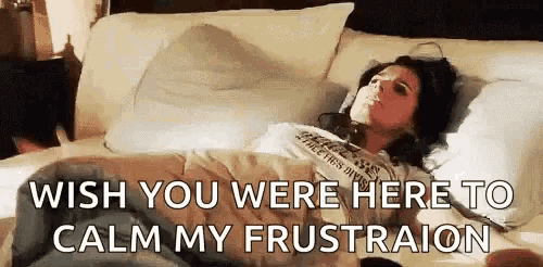 a woman is laying in bed with headphones on and the words `` wish you were here to calm my frustration '' .