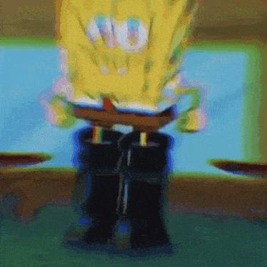 a blurry picture of spongebob squarepants standing on a table with his legs crossed .