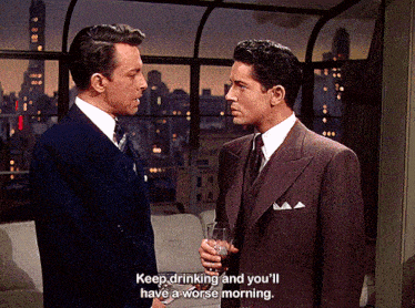a man in a suit and tie is talking to another man in a suit