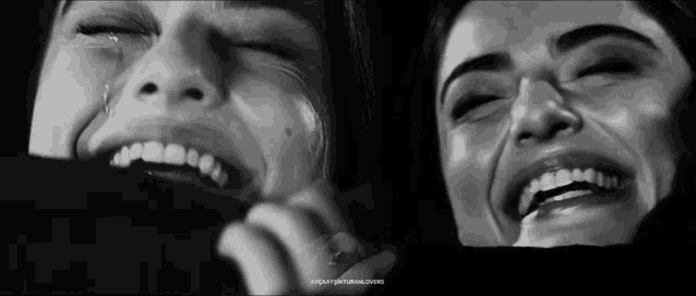 a black and white photo of a woman crying and smiling with her eyes closed .
