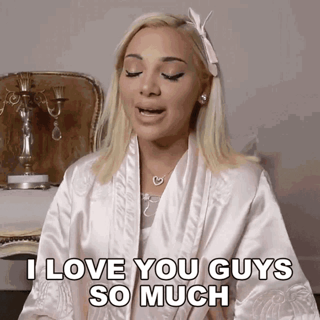 a woman in a satin robe says i love you guys so much