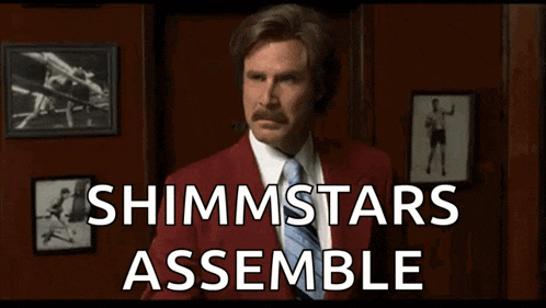 a man in a red suit and tie is holding a fist in front of a sign that says shimmstars assemble .