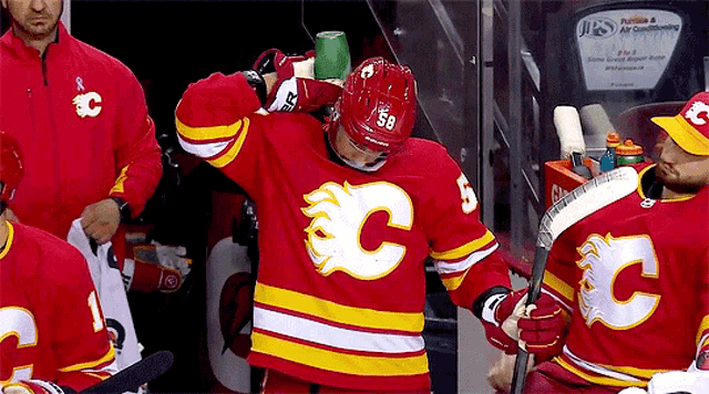 a hockey player in a red jersey with the letter c on it