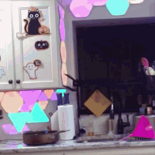 a kitchen with a cat and a ghost on the cabinet