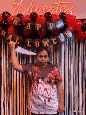 a woman in a bloody shirt is holding a knife in front of a halloween banner