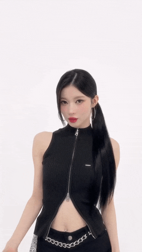a woman wearing a black tank top with a zipper on it