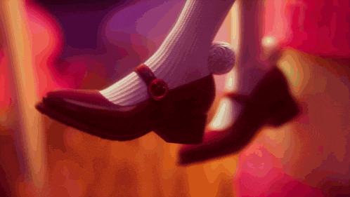 a close up of a person 's foot wearing a red shoe