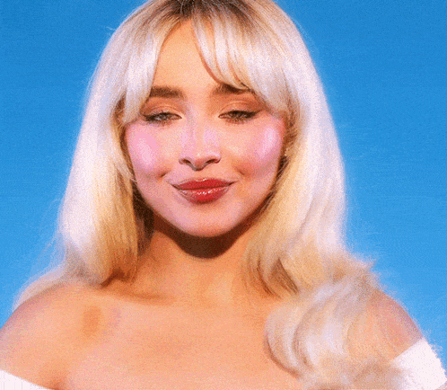 a close up of a woman 's face with blonde hair