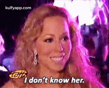 mariah carey is smiling and saying `` i don 't know her . ''