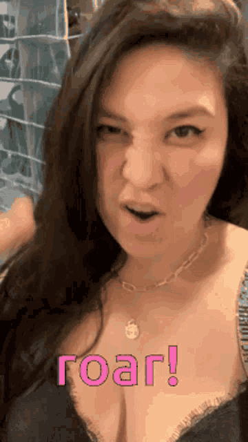 a woman is making a funny face and the words roar are on her chest