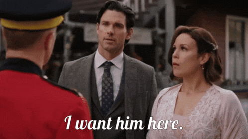 a man in a suit and tie stands next to a woman in a wedding dress and says i want him here