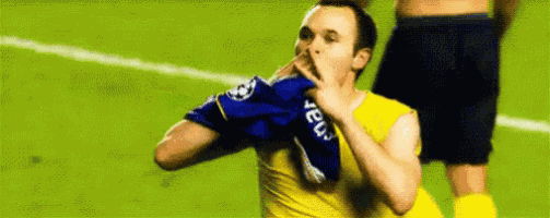 a soccer player in a yellow shirt is covering his mouth with his hand while celebrating a goal .