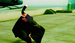 a person in a black cape with red bull on their head