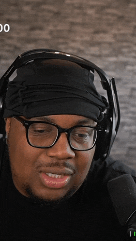 a man wearing headphones and a headband with the number 00 on the bottom right