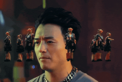a man with a chain around his neck is surrounded by a group of people