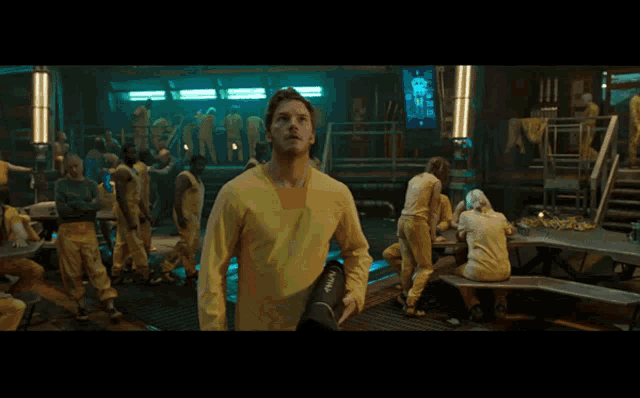 a man in a yellow shirt says " all shouting " at the bottom of the screen
