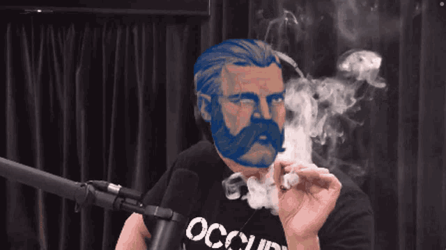 a man with a blue beard and mustache is smoking a cigarette and wearing an occupy shirt