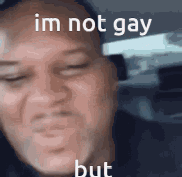 a close up of a man 's face with the words `` i 'm not gay but '' written on it