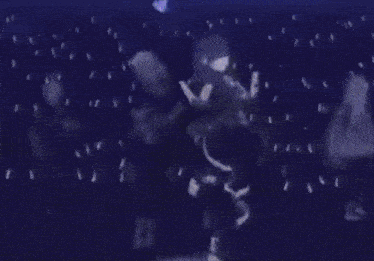 a couple of people are standing next to each other in a dark room in the rain .