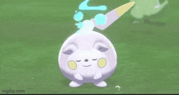 a pokemon with a knife on its head is standing on a grassy field .