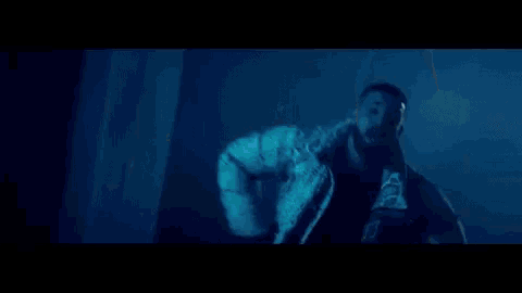 a man with a beard is being attacked by a monster in a dark room in a video game .