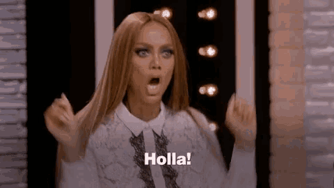 a woman is making a surprised face and saying holla !