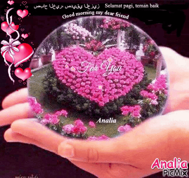 a person is holding a glass ball with a heart in it and the words good morning my dear friend