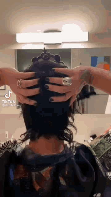 a tik tok video of a woman getting her hair cut