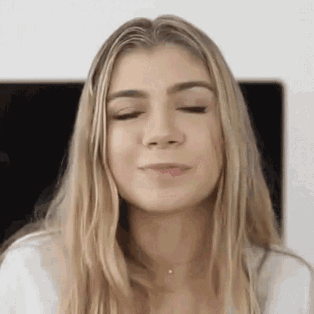 a close up of a woman with her eyes closed and her mouth open .