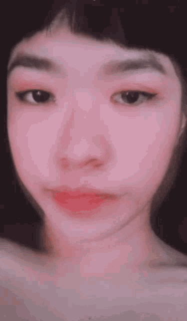 a close up of a girl 's face with a pink lip