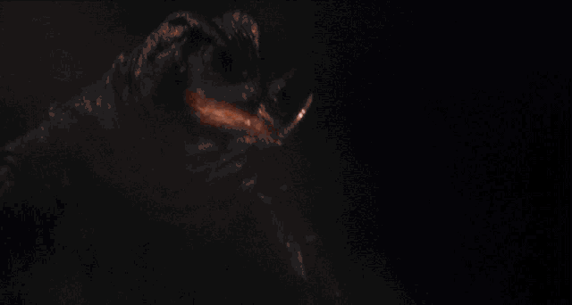 a close up of a monster 's face with a light coming out of its mouth