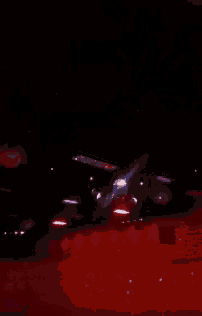 a person is standing in a dark room with a glowing object in the background .