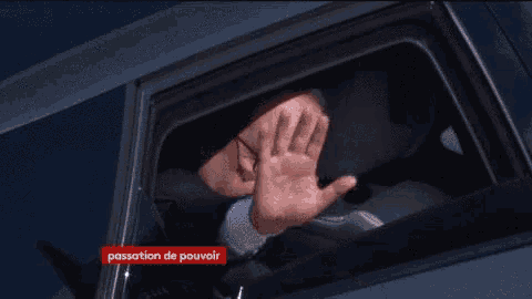a man covering his face in a car with the words passation de pouvoir in the corner