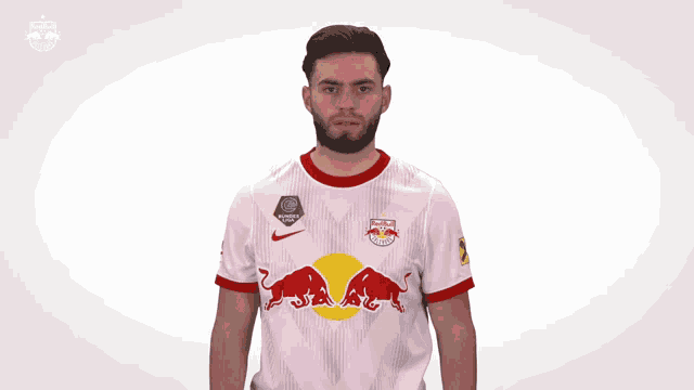 a man wearing a white red bull jersey