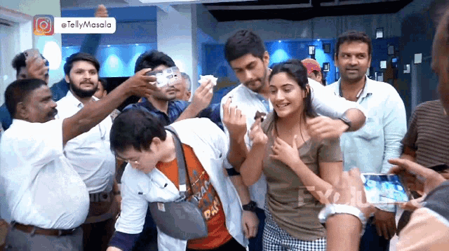 a group of people are posing for a picture with a tag that says tellymasala