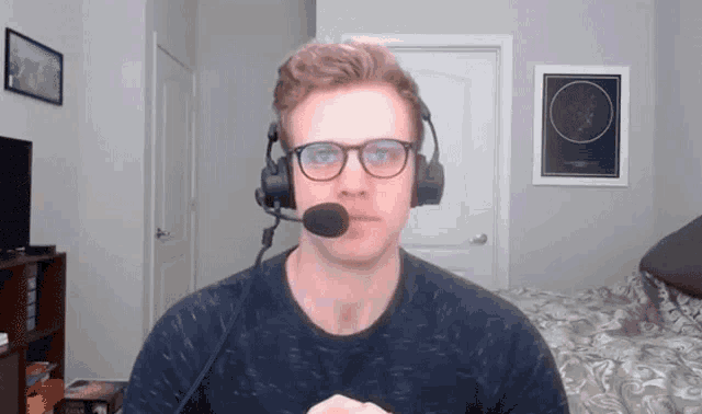 a man wearing glasses and headphones with a microphone