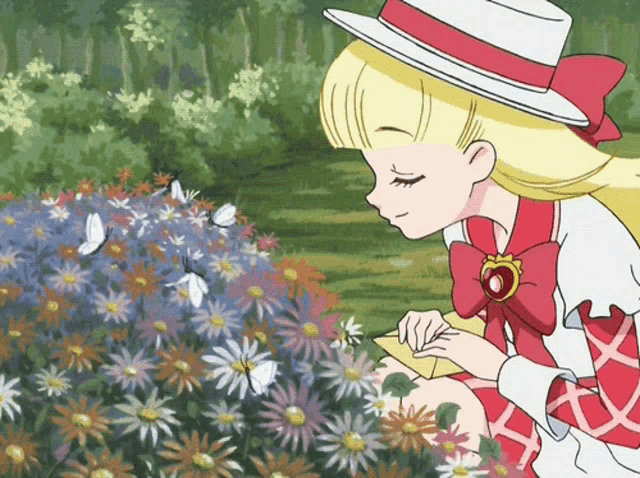a girl in a red and white dress is writing on a piece of paper in front of a bunch of flowers