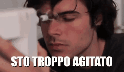a close up of a man 's face with the words sto troppo agitato written on it .