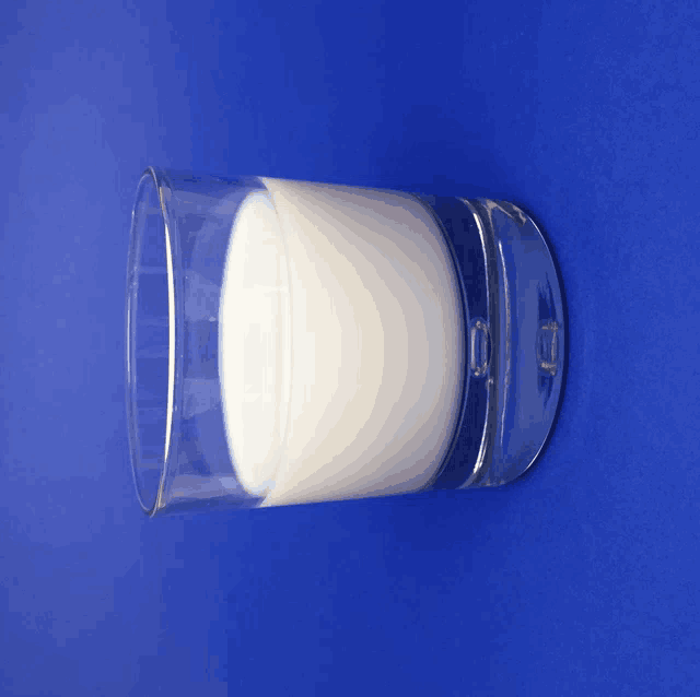 a glass of milk is on a blue background