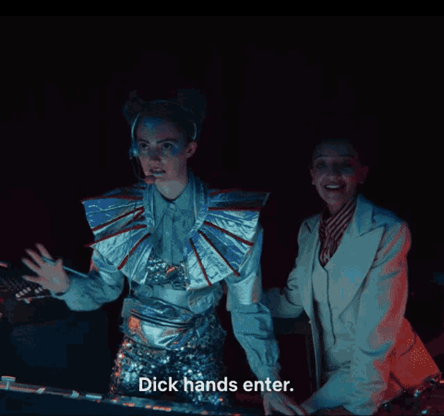two women are standing next to each other in a dark room with the words " dick hands enter " on the bottom